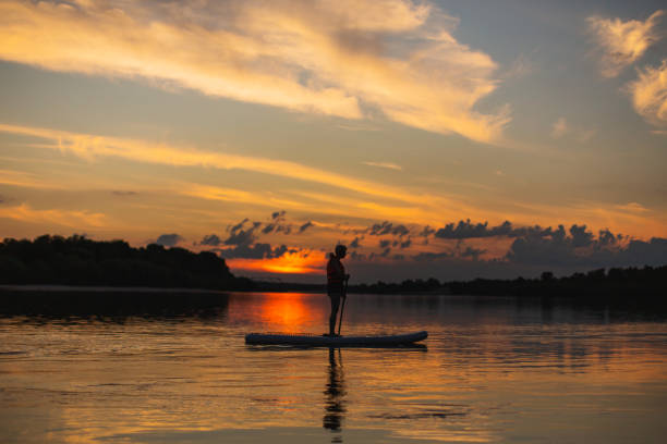 istock Blonde woman on sap board on the river. 2143097091