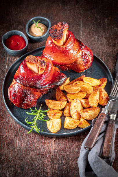 istock Aromatic roasted pork knuckle served with potatoes and pickled cabbage. 2143117932