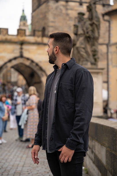 istock Unrecognizable young male tourist posing on Charles Bridge in Prague 2143180195