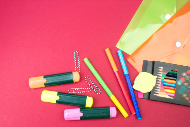 Back to school. Stationery on a Burgundy table. Office desk with copy space. Flat lay