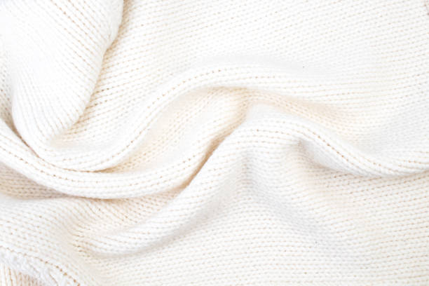 istock A sweater or scarf -tone texture large knitting. Knitted background. Woolen manual car, handmade. 2143263297