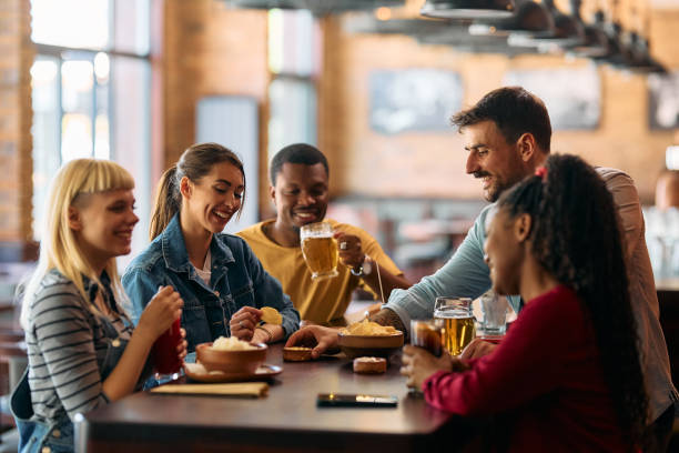 istock Young happy friends enjoying in gathering in a pub. 2143279783