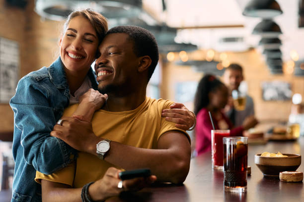 istock Happy couple in love on a date in a pub. 2143280859