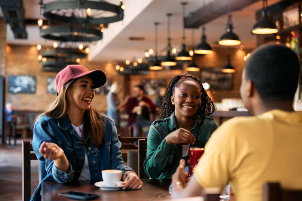istock Group of happy friends enjoying in conversation while gathering in pub. 2143283472