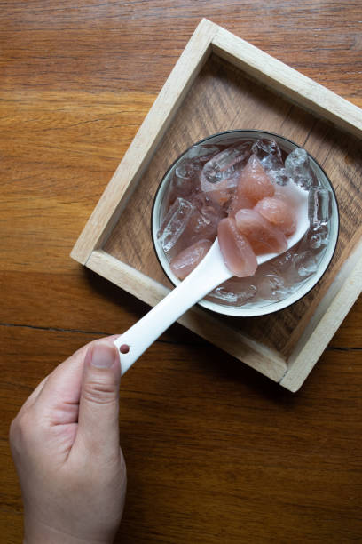 istock Scooping Young Foxtail Palm Seeds in Syrup with Ice 2143302409