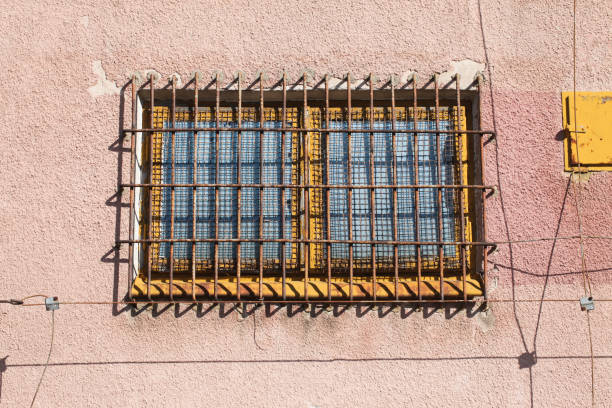 istock Abandoned warehouse window. Rusty grate window. Safety security protection. 2143319504