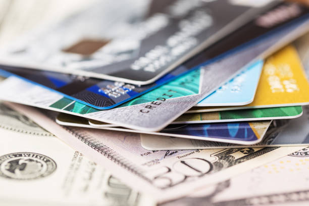 istock Colorful stack of credit cards and US dollar banknotes. Selective focus. Macro. 2143323536