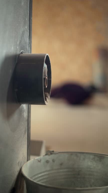 Close-up of dust spilling out of a carpet beating machine in production. Professional carpet cleaning