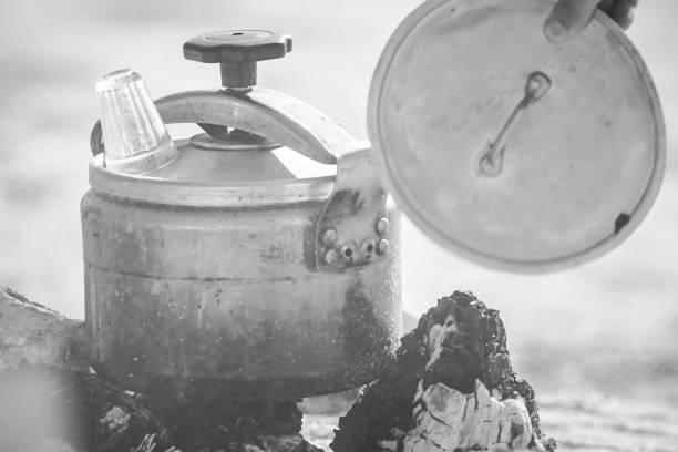 istock Ventilating a pressure cooker over wood and charcoal fire. 2143363654
