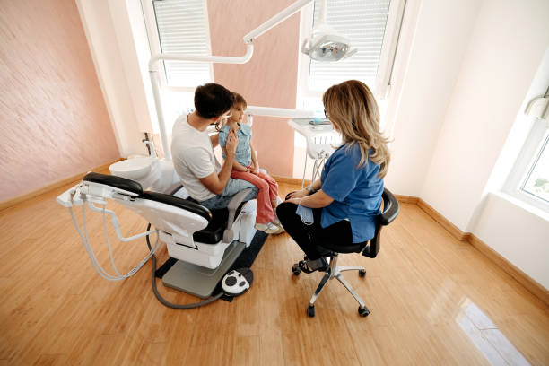 istock Girl at the dentist with her father 2143376233