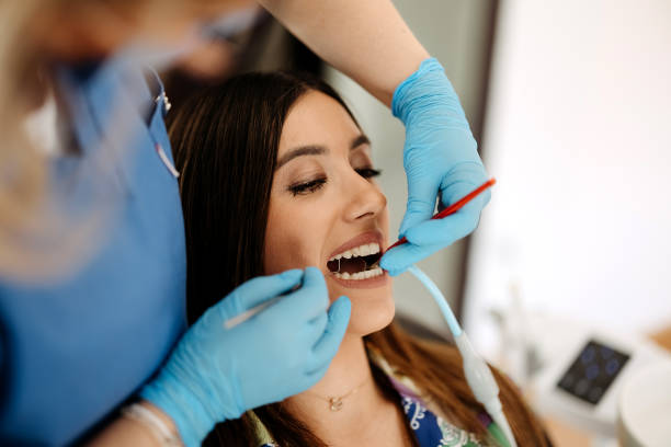 istock Woman fixes a tooth at the dentist 2143390438