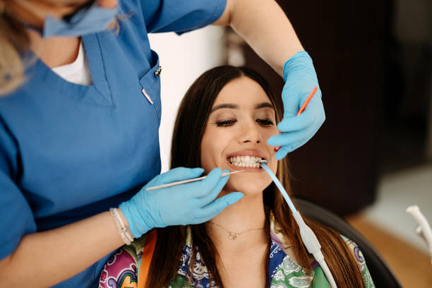 istock Woman fixes a tooth at the dentist 2143390960