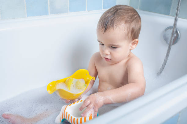 istock toddler playing with bath water 2143420358