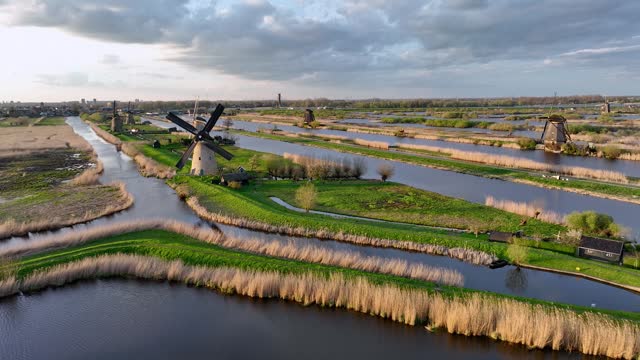 Aerial View to the wooden windmills at sunset in the Netherlands village