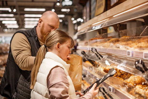 istock Handsome man and beautiful daughter using technology whilst grocery shopping 2143447760