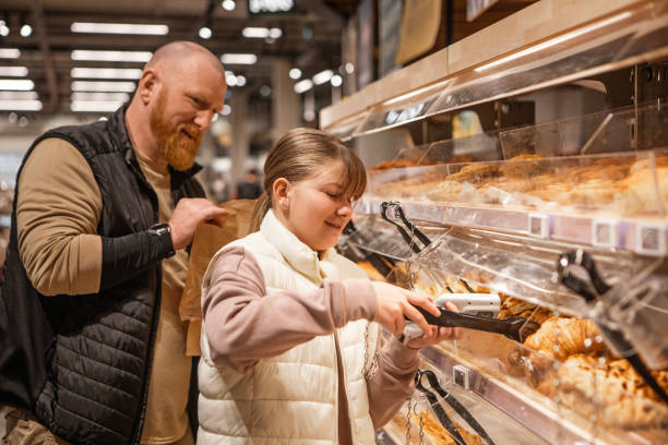istock Handsome man and beautiful daughter using technology whilst grocery shopping 2143447984