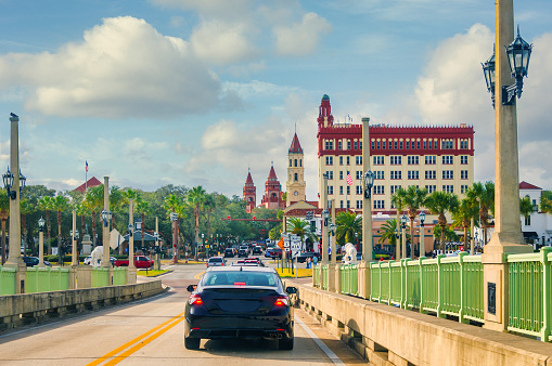 Vehicular traffic drives over the Intracoastal Waterway on the famous Bridge of Lions heading toward downtown St. Augustine that is decorated for the Christmas Season