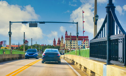 Vehicular traffic drives over the Intracoastal Waterway on the famous Bridge of Lions drawbridge heading to and from downtown St. Augustine.