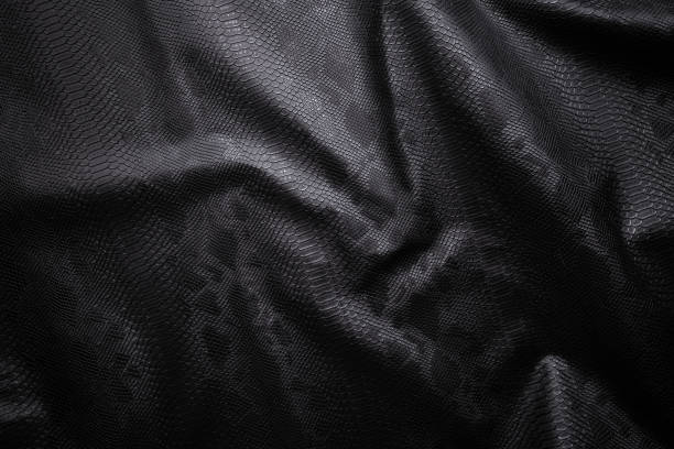 Vegan faux Snakeskin leather texture. minimalist and elegant textile. simple dark black backdrop
