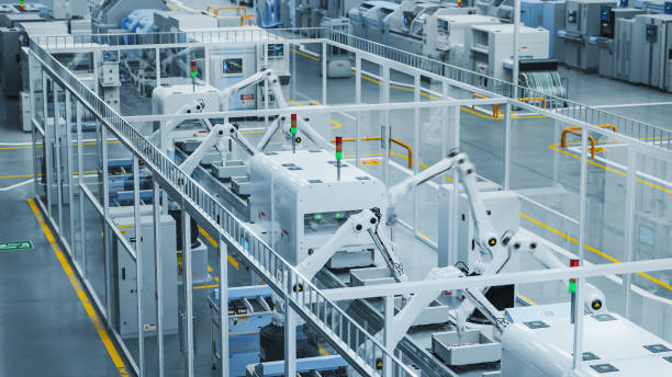 istock 3D Render Of a Modern Manufacturing Plant with Advanced Robotic Arms Operating an Assembly Line with Electronic Components Moving on a Conveyor Belt. Factory Producing Large Amounts of Devices. 2143480422