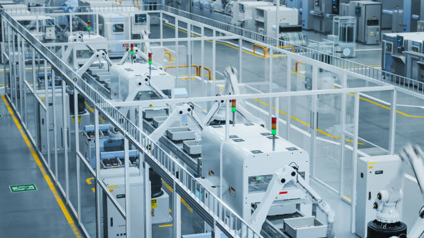 istock 3D Render Of Modern Manufacturing Plant with Advanced Robotic Arms Operating an Assembly Line with Electronic Components Moving on a Conveyor Belt. Factory Producing Large Amounts of Devices. 2143486811