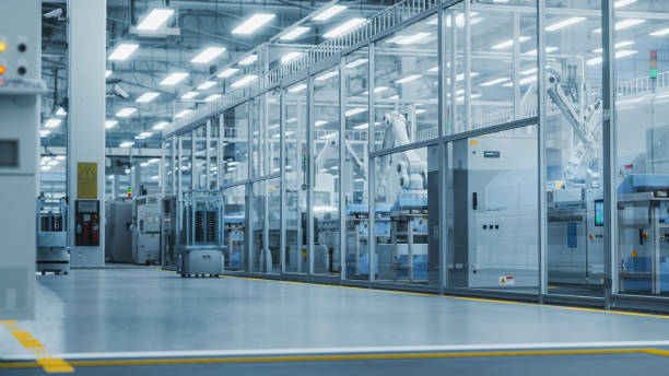 istock 3D Render: Automated Support Vehicles Transport Electrical Components, Circuit Boards and Microchips. Separate Facility with an Assembly Line Producing High-Quality Precise Equipment with Robotic Arms 2143488942