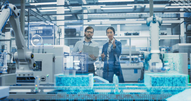 istock Electronics Factory Assembly Line Digitalization: Automated Robot Arms Manufacturing Advanced Equipment. Managers Discussing Work while Futuristic AI Computer Vision Analyzing, Scanning Conveyor Line 2143499689