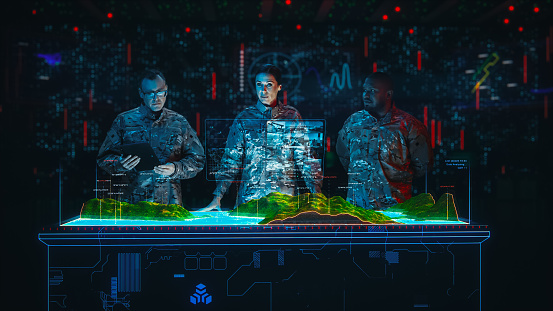 Futuristic Warfare: Military Intelligence Specialists Use Augmented Reality Holographic Table Map to Scan Enemy Terrain. Army Recoinessance Using Sattelite Surveillance Analysis Technology.