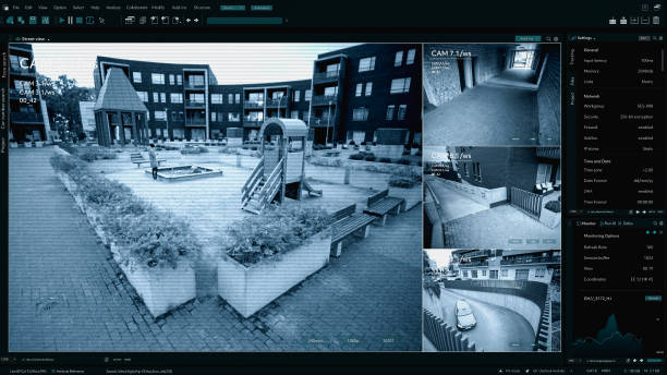 istock Surveillance CCTV Camera, Multiple Screens Show Secure Outside Residential Building Block with Mother and Child Playing on the Playhround. Security Screen Replacement Template for Computer Displays 2143508714