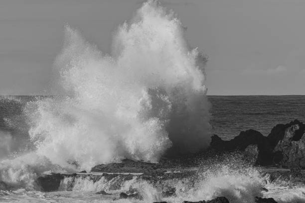 istock large waves hitting the volcanic rocks 2143513987