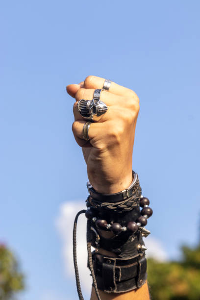 istock Man on rock with wristbands and with hand symbol 2143533488