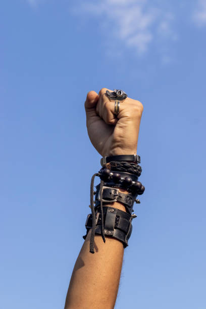 istock Man on rock with wristbands and with hand symbol 2143539711