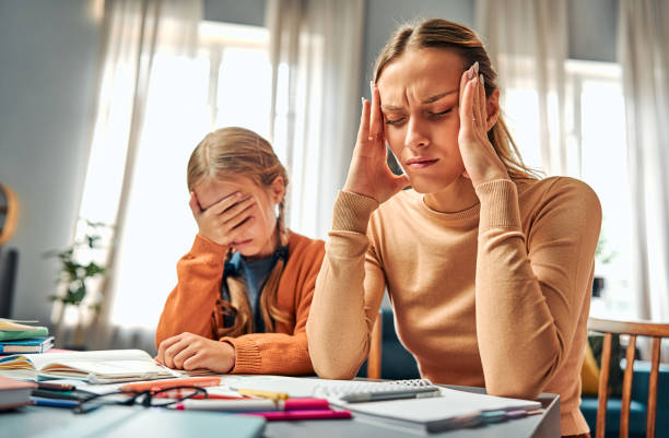 istock Lack of patience. Irritated woman suffering misunderstanding with daughter while doing exercises in textbooks 2143552231