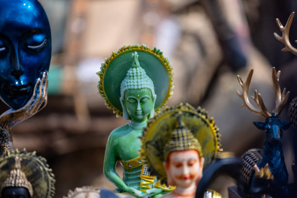 Beautiful handmade dolls of miniature folk musicians performing in a band of classical Indian music is displayed in a shop for sale in blurred background. Indian art and handicraft.
