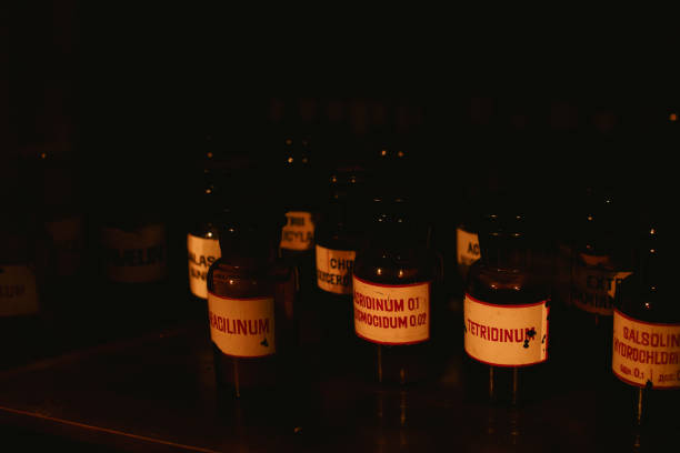 Multiple pharmaceutical liquids on a shelf in an old pharmacy basement