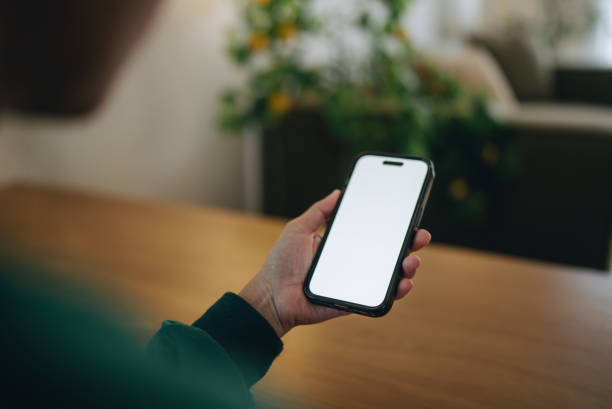 istock Female hand holding a smartphone Close-up 2143605193