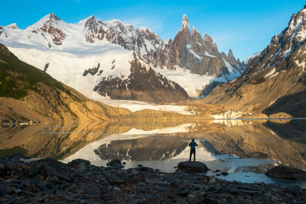 istock Mature hiker reflected in mountain lake 2143636987