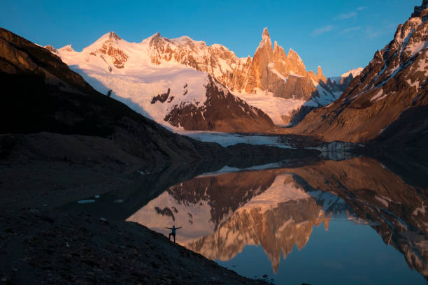 istock Mature hiker reflected in mountain lake 2143636996