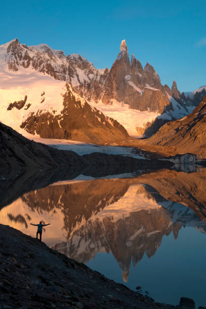 istock Mature hiker reflected in mountain lake 2143637505