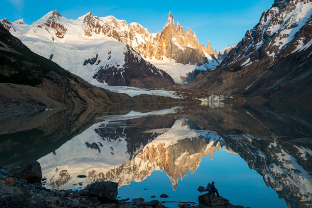 istock Mature hiker reflected in mountain lake 2143637511