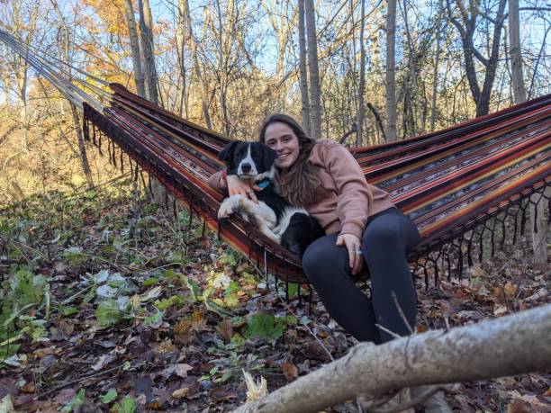 istock A woman in a hammock with her dog 2143741634