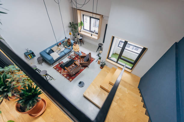Two women enjoying a relaxing afternoon in living room adorned with modern furniture and decor.