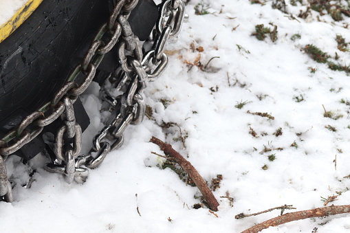 Tractor tires, tractor that saws trees in the forest and needs to chain to get through snow and ice.