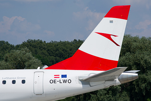 Austrian Airlines Embraer E195 vertical stabilizer close-up while taxiing after landing in Lviv