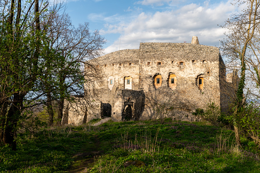Medieval castle ruins on the Somló Hill with some vegetation on a sunny day in springtime.
