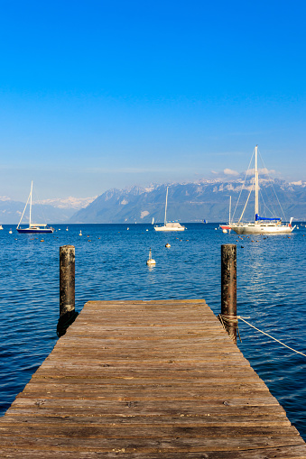 Wooden pier overlooking the Alps and Lake Geneva in Switzerland