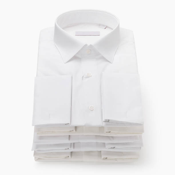 istock Five white classic folded men's shirts with long sleeves and cufflinks on a light background 2143812521