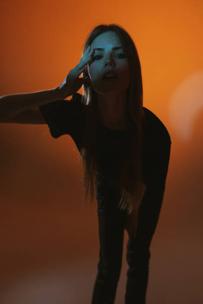 istock Fashion model in studio with neon light. 2143842489