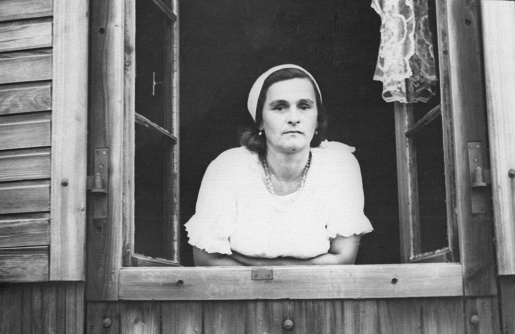 Portrait of a woman looking out of the window. Retro. Chasov Yar, Ukraine, 1960s.