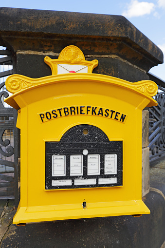 Dresden, Germany - September 19, 2015: Painted yellow mailbox of the Federal Post Office is currently used by Deutsche Post AG